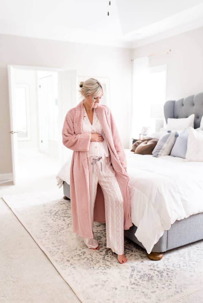 pregnant woman wearing cozy soma intimate matching pink long sleeve and pants pajama set with bath robe