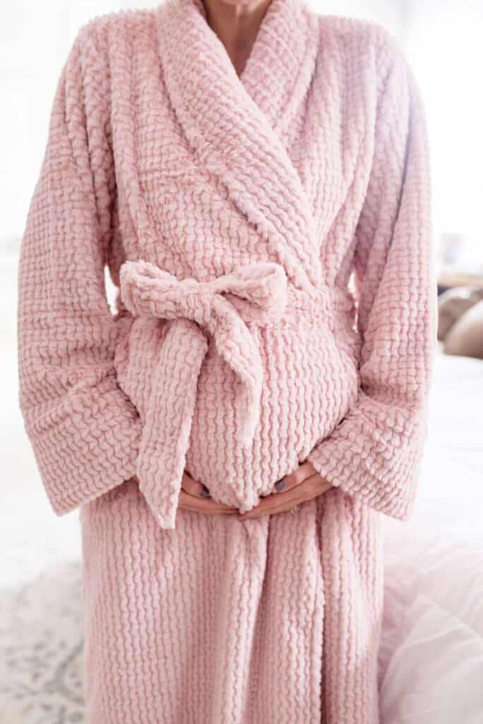 pregnant woman wearing cozy pink soma intimate bath robe