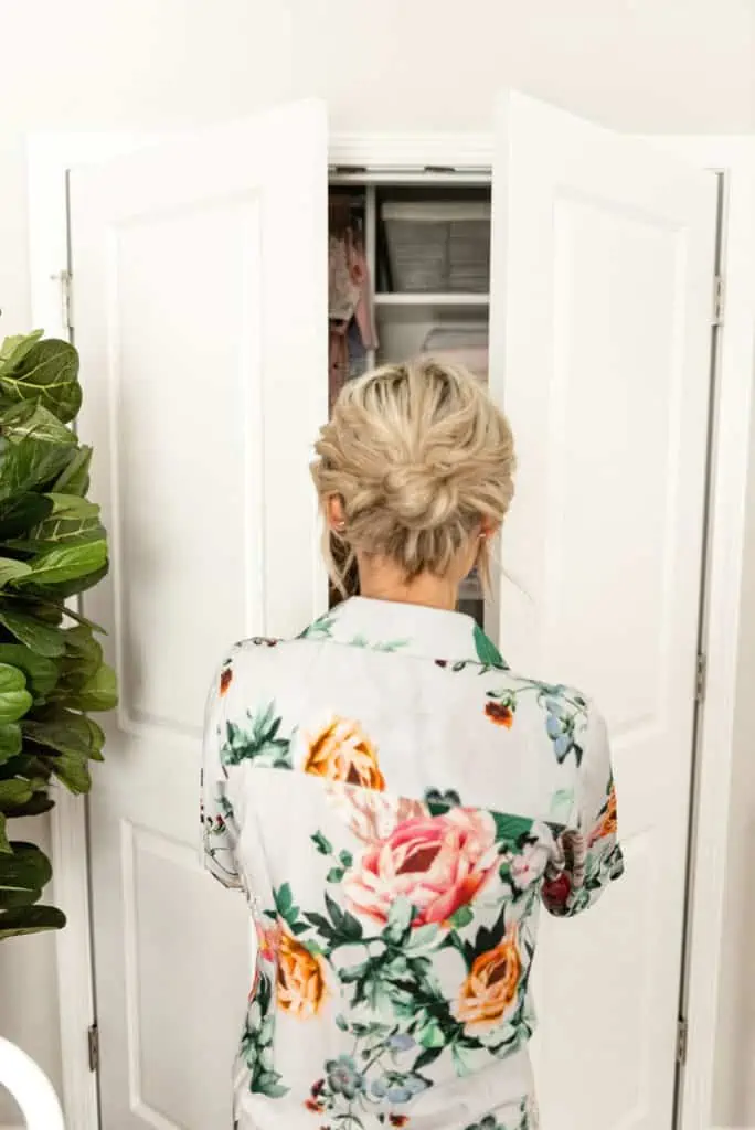 blond woman opening nursery closet