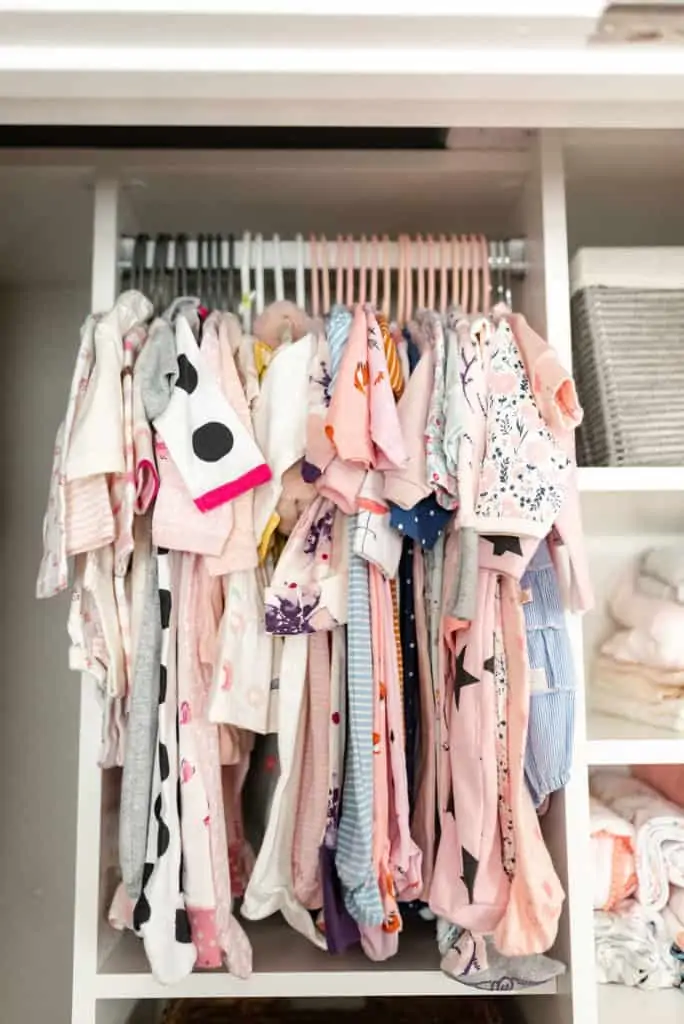 baby clothes hanging in california closets nursery