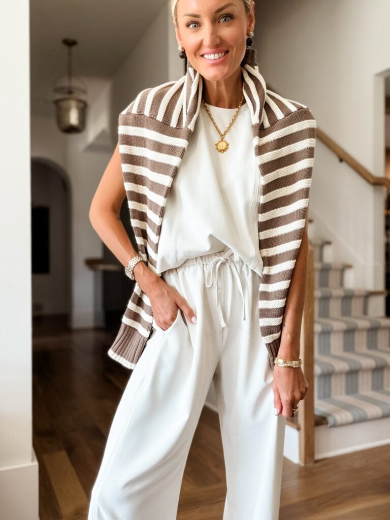 White matching set with brown striped cardigan draped over the shoulders.